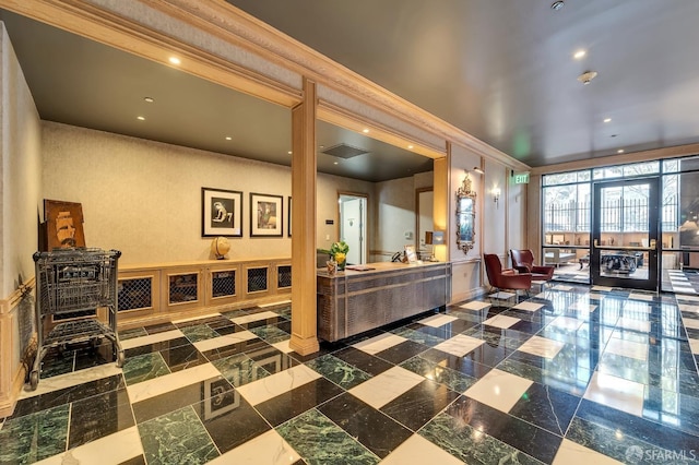reception with crown molding and recessed lighting