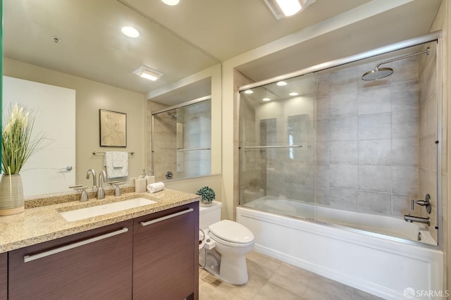 bathroom with tile patterned floors, toilet, combined bath / shower with glass door, vanity, and recessed lighting
