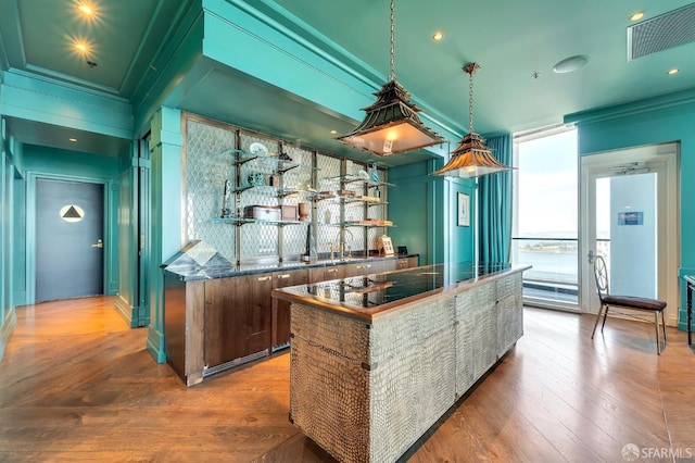 indoor wet bar with hardwood / wood-style floors and crown molding