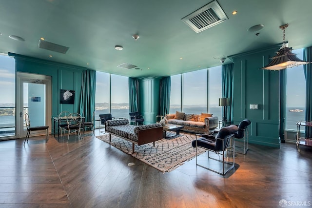living area with a wall of windows and dark wood-type flooring