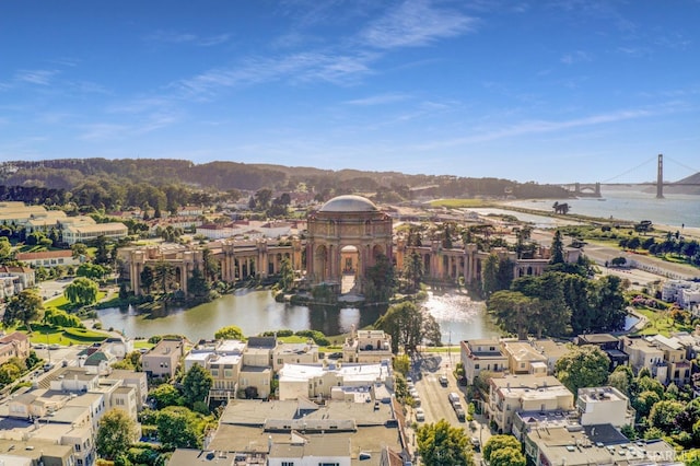 aerial view of property and surrounding area with a nearby body of water and a notable bridge