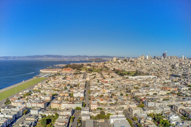 aerial view of property and surrounding area with a large body of water and nearby urban area