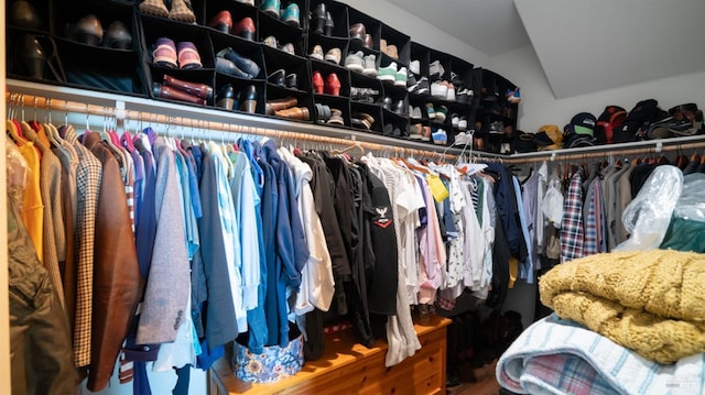 walk in closet with vaulted ceiling