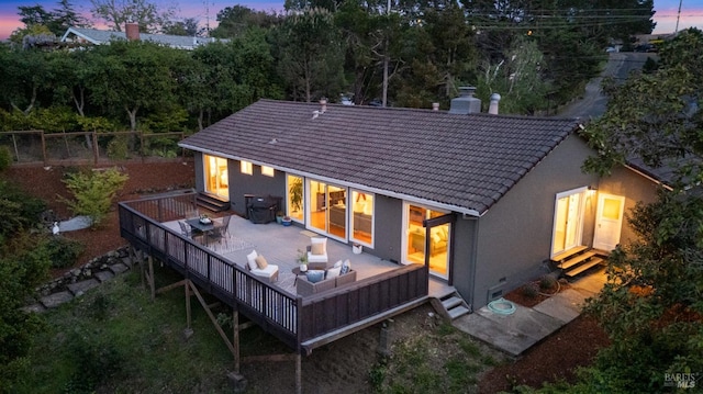 15 Manor View Dr, Fairfax, CA 94930 - back of property at dusk with a tiled roof, stucco siding, a deck, a chimney, and an outdoor hangout area