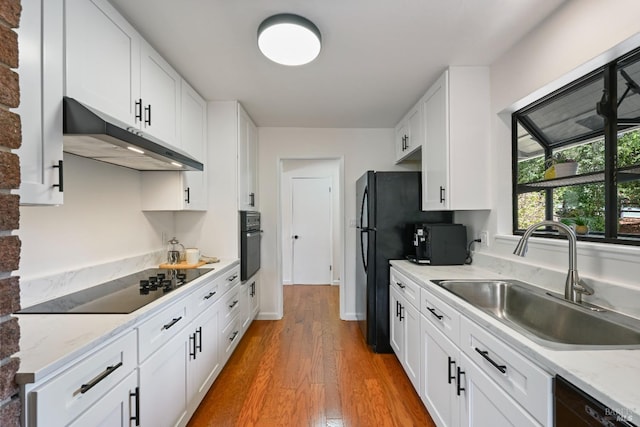 15 Manor View Dr, Fairfax, CA 94930 - kitchen with black appliances, wood finished floors, under cabinet range hood, white cabinetry, and light stone counters
