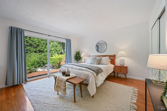 15 Manor View Dr, Fairfax, CA 94930 - bedroom with access to exterior, wood finished floors, and a textured ceiling