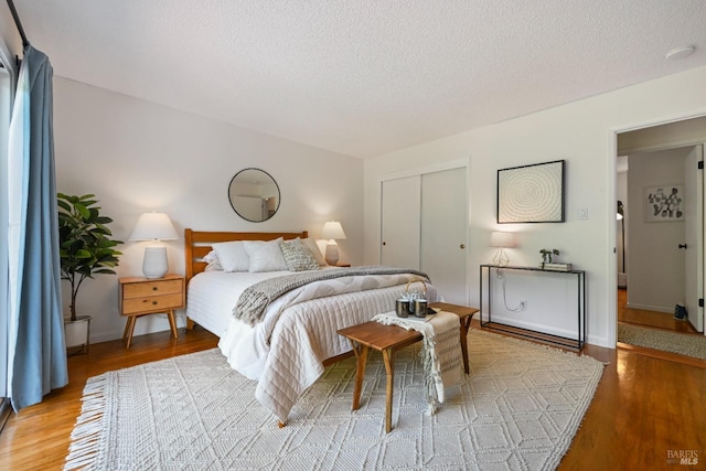 15 Manor View Dr, Fairfax, CA 94930 - bedroom featuring wood finished floors, a closet, and a textured ceiling