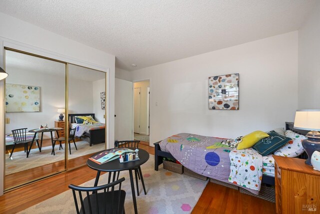 15 Manor View Dr, Fairfax, CA 94930 - bedroom featuring wood finished floors, a closet, and a textured ceiling