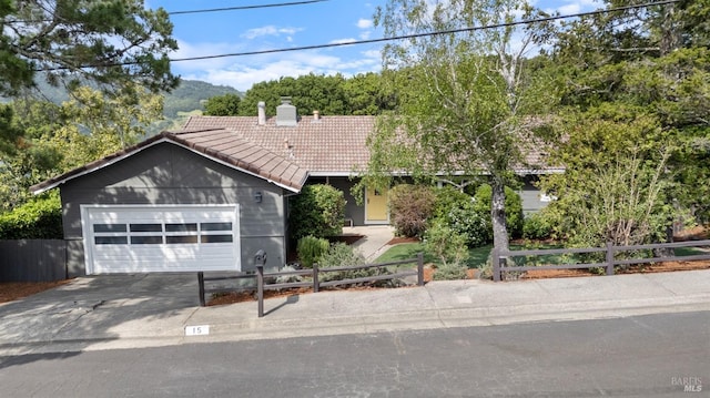 15 Manor View Dr, Fairfax, CA 94930 - ranch-style home featuring a tile roof, a chimney, concrete driveway, an attached garage, and stucco siding