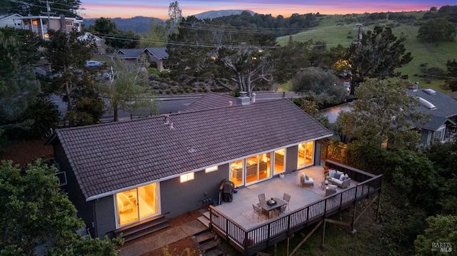 15 Manor View Dr, Fairfax, CA 94930 - back of property at dusk featuring a tiled roof, a wooden deck, and an outdoor hangout area