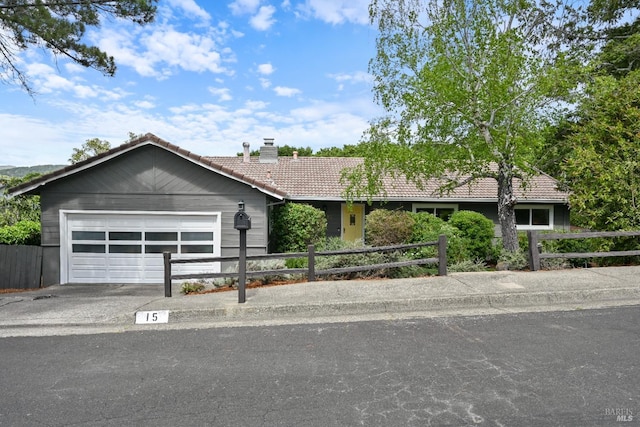 15 Manor View Dr, Fairfax, CA 94930 - ranch-style home with a tile roof, a chimney, concrete driveway, a garage, and fence private yard