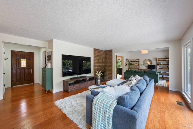 15 Manor View Dr, Fairfax, CA 94930 - living room featuring a textured ceiling, light wood-type flooring, and a brick fireplace
