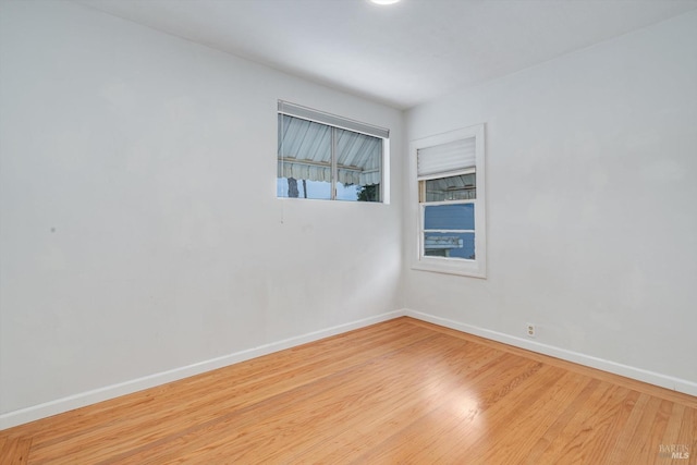 empty room featuring baseboards and wood finished floors