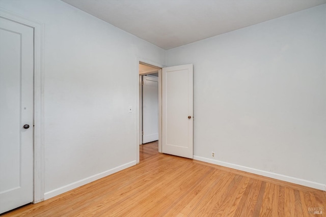 unfurnished bedroom with light wood finished floors and baseboards