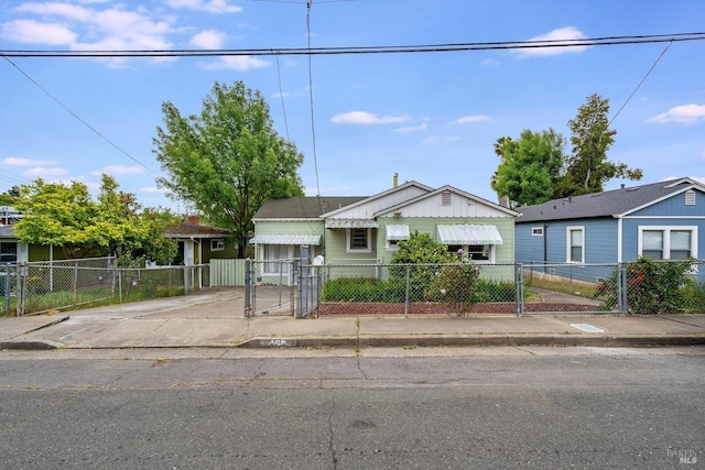 bungalow with a gate and a fenced front yard