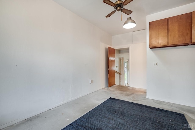 unfurnished room featuring unfinished concrete floors and a ceiling fan