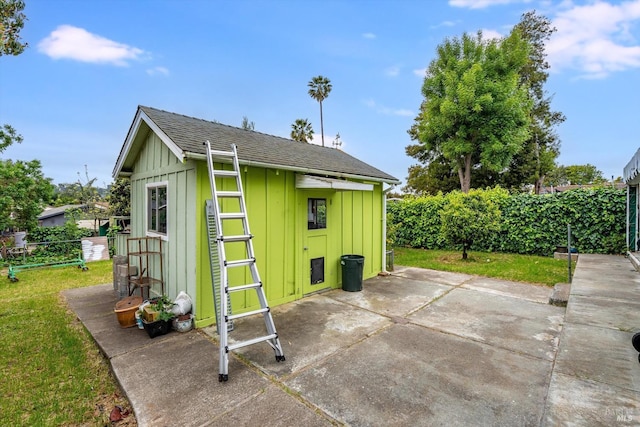 view of outbuilding featuring fence and an outdoor structure