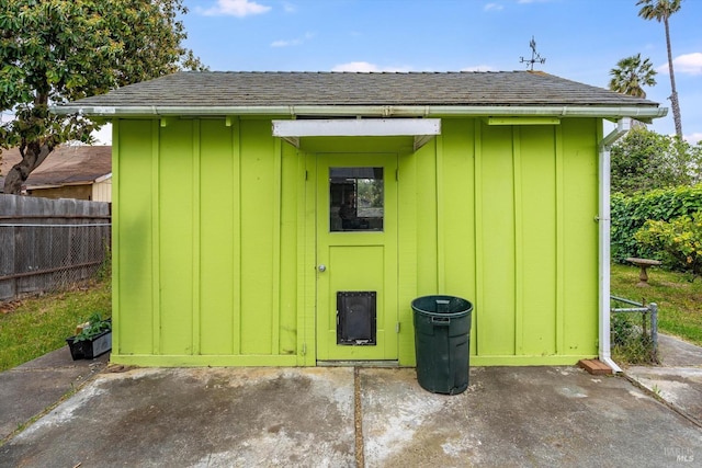 view of shed featuring fence