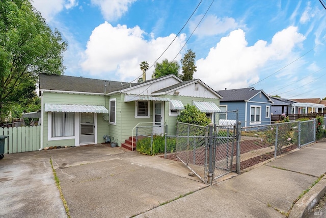 bungalow-style house featuring fence and a gate