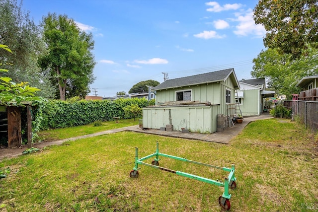 exterior space featuring fence, board and batten siding, and a yard