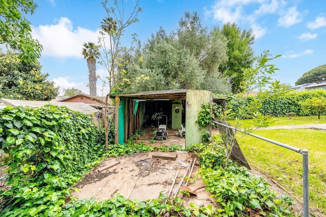 view of shed featuring fence and a garden