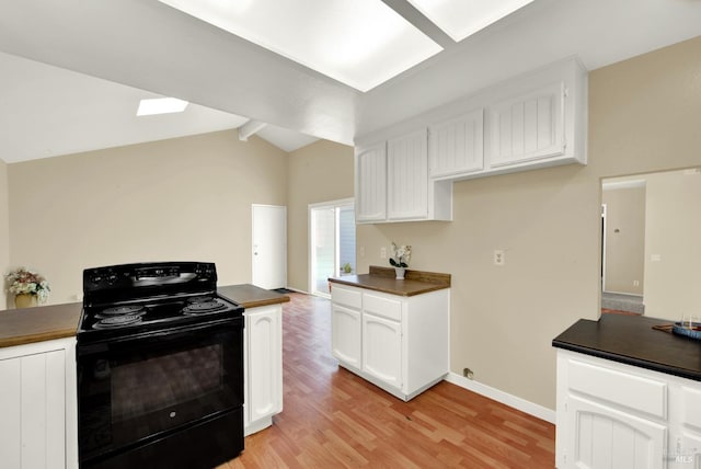 kitchen featuring white cabinets, dark countertops, vaulted ceiling with beams, light wood-style floors, and black electric range