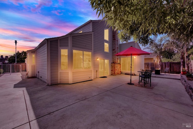rear view of house featuring a patio area and fence