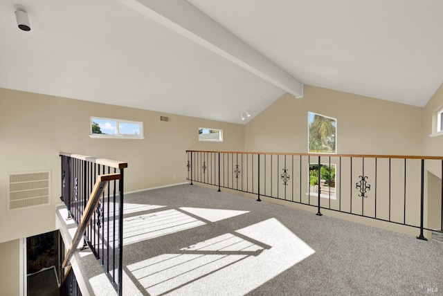 additional living space with vaulted ceiling with beams, visible vents, and carpet