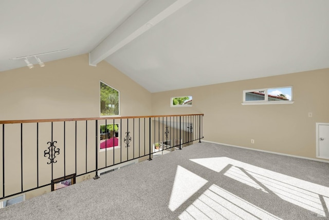 additional living space featuring vaulted ceiling with beams, baseboards, and carpet