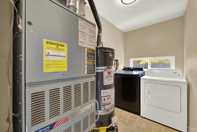 clothes washing area featuring washer and clothes dryer, secured water heater, heating unit, and laundry area