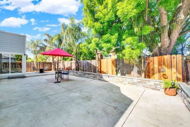 view of patio featuring a fenced backyard and outdoor dining area