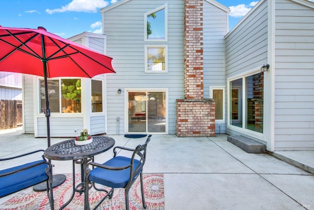 back of property with a patio and fence