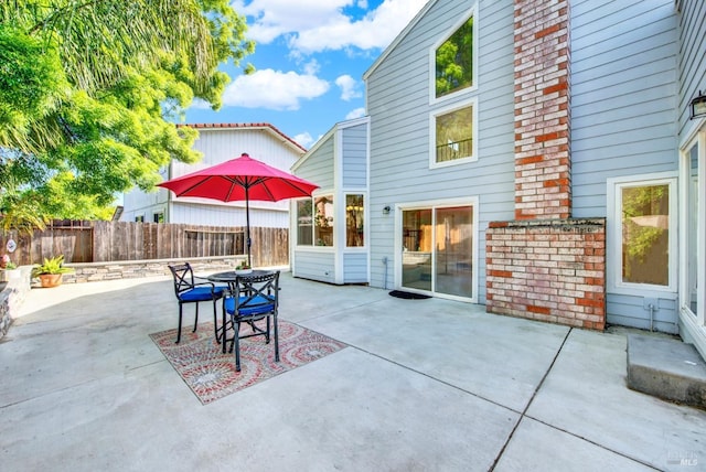 view of patio / terrace featuring fence