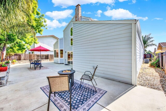 515 Paula Dr, Suisun City, CA 94585 - fenced backyard with an outdoor fire pit, a patio area, and central AC unit