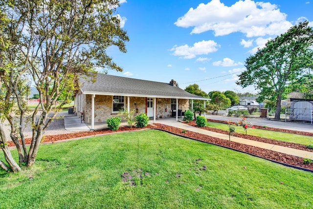 view of front of home featuring a chimney, stone siding, a shingled roof, covered porch, and a front yard