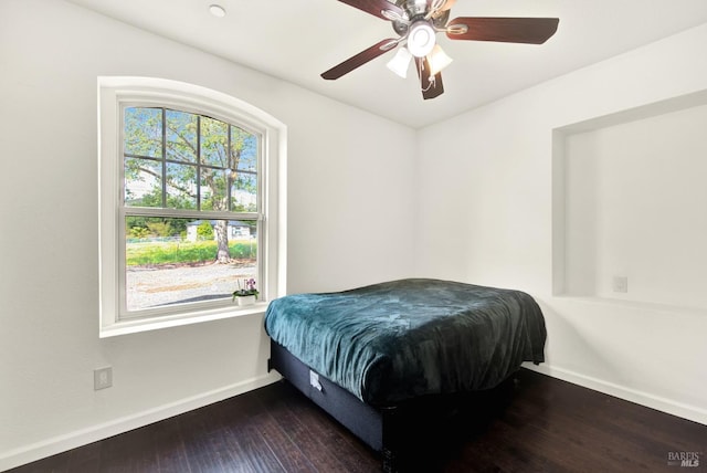 bedroom featuring hardwood / wood-style flooring, baseboards, and ceiling fan