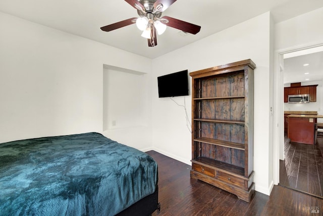bedroom featuring dark wood finished floors, baseboards, and a ceiling fan