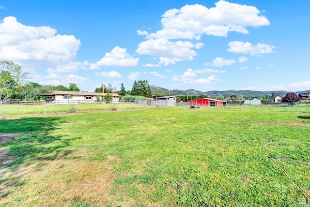 view of yard with fence and a mountain view