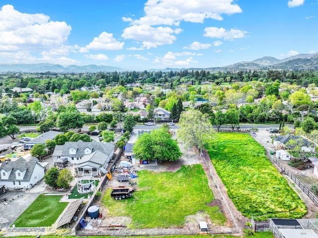 drone / aerial view featuring a residential view and a mountain view