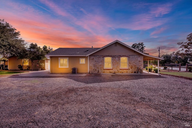ranch-style home with stone siding and fence