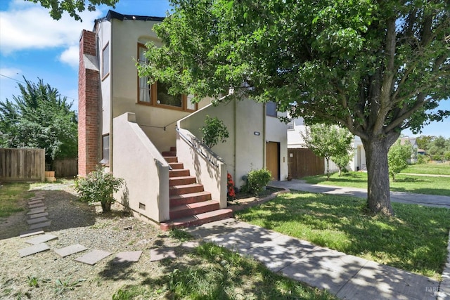 1467 Ohio St, Vallejo, CA 94590 - view of front of property with stucco siding, stairway, and a chimney