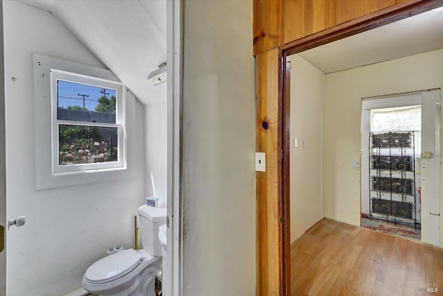 1467 Ohio St, Vallejo, CA 94590 - half bath featuring wood finished floors, vaulted ceiling, and toilet