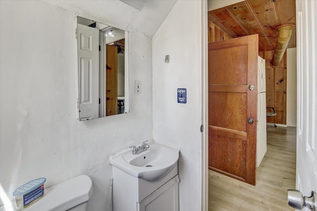 1467 Ohio St, Vallejo, CA 94590 - bathroom featuring toilet, wood finished floors, vanity, and lofted ceiling