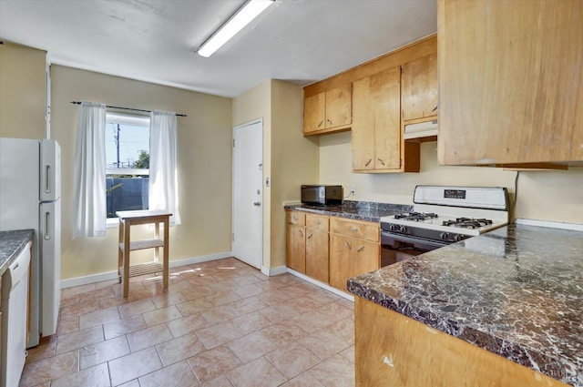 1467 Ohio St, Vallejo, CA 94590 - kitchen with white appliances, under cabinet range hood, dark countertops, and baseboards