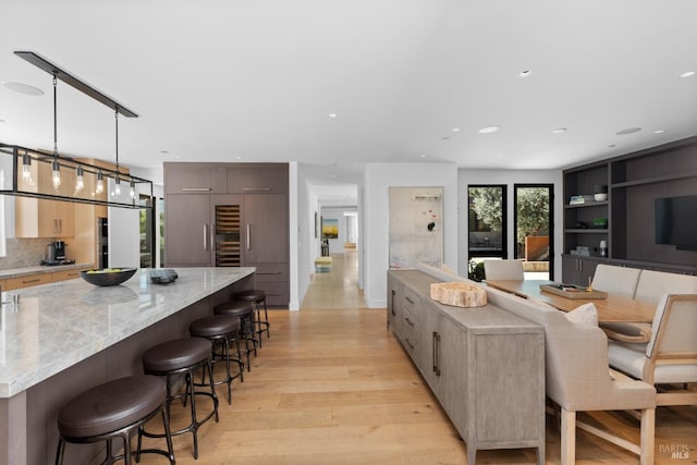 living area with light wood-style floors and recessed lighting