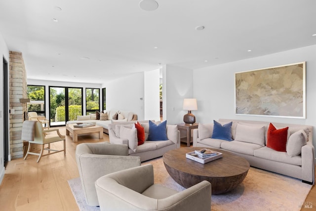 living room with light wood finished floors and recessed lighting