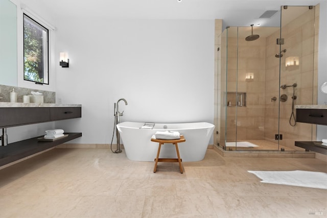 full bathroom featuring a shower stall, a soaking tub, baseboards, tile patterned flooring, and visible vents