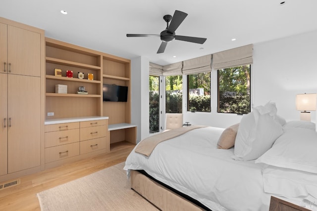 bedroom with a ceiling fan, visible vents, and light wood-type flooring