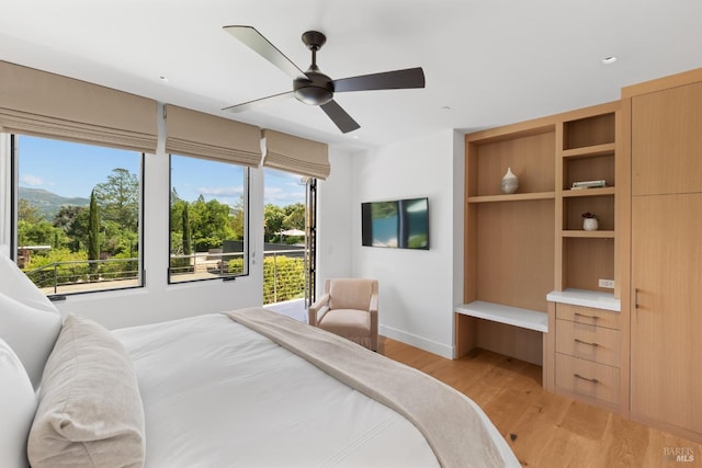 bedroom featuring ceiling fan, light wood-style flooring, baseboards, and access to outside