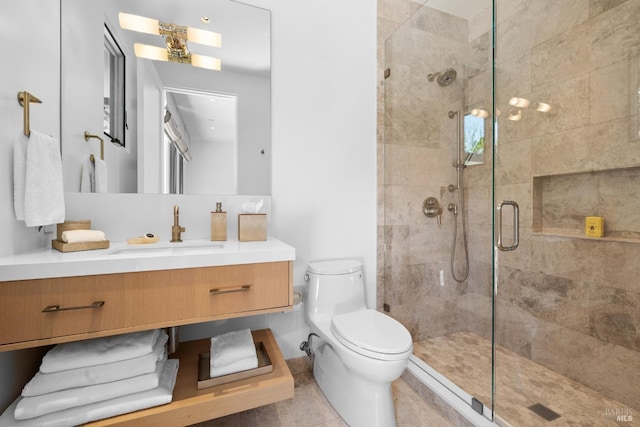 full bathroom with a shower stall, toilet, and vanity